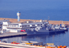 Oran, Algeria / Algrie: harbor - the Rais Korfu (903) - Murat Reis / Koni class frigate - Soviet Project 1159, built in Zelenodolsk - Algerian Navy - Societe General Maritime building - photo by M.Torres | le port - la frgate Rais Korfu (903) et le difice de la Societe General Maritime - Bassin Mostagane