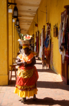 Colombia - Cartagena: colonnade and market - woman with fruit over her head, local Carmen Miranda - photo by D.Forman