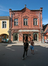 Estonia - Prnu: teenage smokers and brick faade - people - Baltic - photo by A.Dnieprowsky