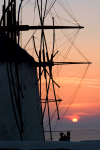 Greek islands - Mykonos (Hora) / Mikonos / JMK - Hora: windmills at sunset with couple - photo by D.Smith