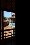 Guinea Bissau / Guin Bissau - Bafat, Bafat Region: view of the old colonial commercial street though window grill / vista da antiga rua comercial do perodo colonial portugus - photo by R.V.Lopes