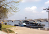 North Korea / DPRK - Pyongyang: Pleasure boat on the Taedong River and the Ongnyu bridge - background the May Day stadium - photo by M.Torres