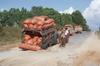 Myanmar - hazardous road - truck in a pot hole - photo by W.Allgwer - Auf den oftmals unbefestigten Strassen in Myanmar ist ein total berladener Pickup in ein Schlagloch geraten und hat Achsbruch erlitten,