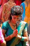 Kathmandu, Nepal: elegant young woman praying with incense - photo by J.Pemberton