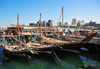 Doha, Qatar: three dhows in the Dhow harbour - south end of the Corniche in the background, from the Ministry of Finance to the Al Hitmi Towers - photo by M.Torres