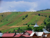 Gura Humorului, Suceava county, southern Bukovina, Romania: roof and rural landscape - long lines of haystacks - photo by J.Kaman