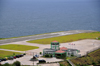 Flat Point, Saba: Juancho E. Yrausquin Airport by the sea - terminal building, heliport and the very short runway - IATA SAB, ICAO TNCS - the shortest airstrip in the world, a large white X indicates that it is not for commercial flights - photo by M.Torres