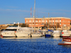 Porto Torres / Pltu Trra, Sassari province, Sardinia / Sardegna / Sardigna: the harbour, built over its Roman predecessor - yachts and Coast Guard building - Cormorano Marina - photo by M.Torres