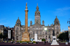 Scotland - Glasgow - George Squarein Glasgow - Robert Burns statue, nearest, the Sir Walter Scott column,and the City Chambers in the background with the sun reflecting in one of its windows - photo by C.McEachern