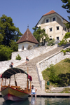 Slovenia - Pletna boat moored at the steps to the church of the Assumption on lake bled - photo by I.Middleton