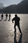 Slovenia - People ice skating across Lake Bled when frozen over in winter - photo by I.Middleton