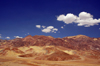 Death Valley National Park, California, USA:  Amargosa Range along Badwater Road - colorful hills - curved bands of clayish rock in vivid hues of green, white, pink and black - photo by M.Torres