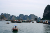 Halong Bay - vietnam: floating village - houses are built on rafts in areas protected by limestone formations - photo by Tran Thai